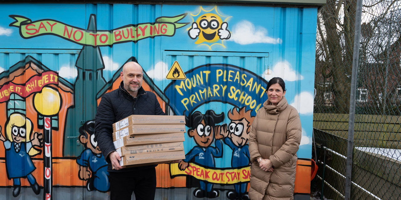James Cash, Managing Director at Superfast IT handing over five new laptops to Mrs Helen Robinson, Head Teacher at Mount Pleasant Primary School